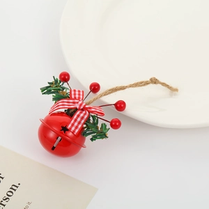 Detail of red Christmas bell with plaid bow, berries, and pine on white dish