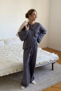 Close-up of dark grey knitted loungewear set featuring soft texture and wide-leg design