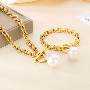 Detailed view of titanium steel OT buckle jewelry set with large pearl pendants