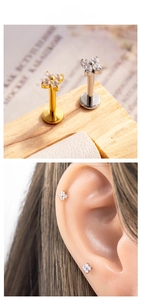 Macro shot of titanium flower labret studs with zircon crystals for cartilage piercing