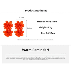 Detail view of large orange fabric flower earrings with 8.6x5.1cm size specifications