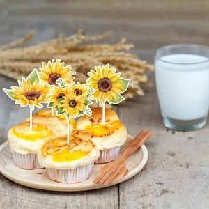 Detail of four sunflower cupcake toppers with watercolor design on a rustic wooden tray
