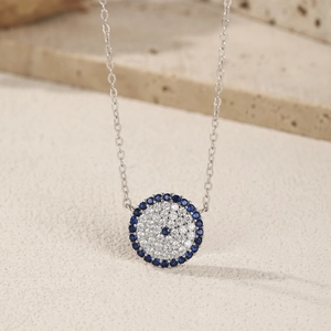 Elegant S925 sterling silver necklace with blue evil eye pendant on a textured stone