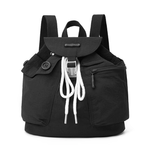 Detailed front view of black nylon backpack featuring multi-pocket design and flap closure