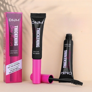 Detail view of DNM thickening brow mascara with vegan fibers and styling wand