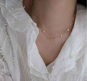 Star-patterned 18K gold-plated titanium steel choker necklace worn on elegant neckline