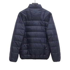 Back view of a lightweight dark blue quilted puffer jacket with stand collar for women
