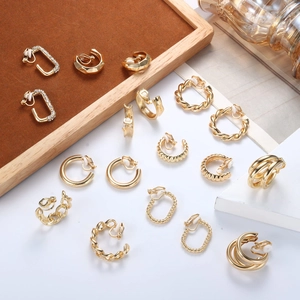 Set of gold C-shaped clip-on earrings in various minimalist geometric designs
