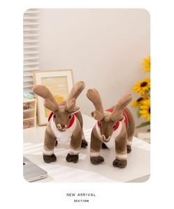 Close-up of a pair of plush Christmas reindeer toys with festive red and green collars