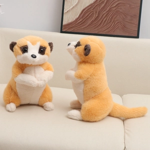 Cute lifelike meerkat plush toy set on white sofa with a warm home decor background