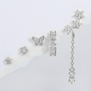 Detail view of 5-piece silver butterfly and flower earring set with zircon accents