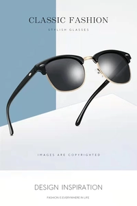 Close-up of classic semi-rimless sunglasses with gold metal trim and silver rivets