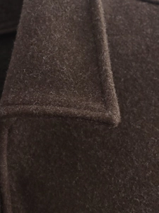 Close-up of deep brown wool blend collar showing high-quality fiber texture and stitching