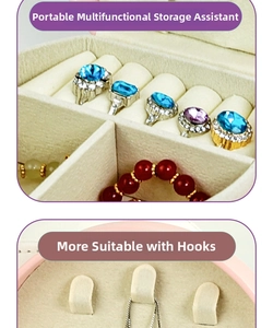 Detail of portable jewelry box featuring ring slots and hooks for necklace storage