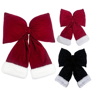 Close-up of velvet and sequin Christmas bows with plush edges in red and black