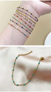 Detail of bohemian gold chain bracelet with colorful oil-dripped beads on satin fabric