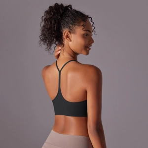 Detail of black sports bra featuring a slim racerback design and brushed fabric texture