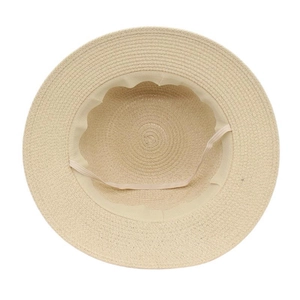 Detailed interior view of beige straw sun hat showing inner sweatband and elastic chin strap