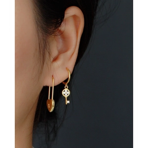 Golden s925 silver hoop earrings with clover key and heart lock charms on model