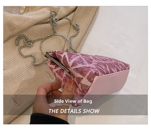 Detail view of pink sequin clutch with metal ring handle and retro metal clasp closure