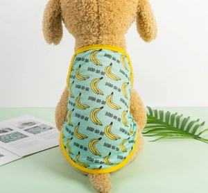 Detail of mint green mesh dog vest with banana prints and breathable fabric