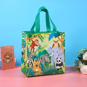 Green non-woven gift bag featuring cartoon forest animals like lion, zebra and monkey