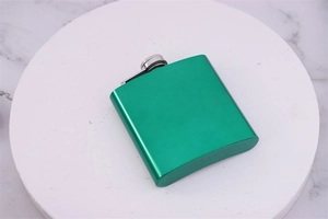 Top-down view of a green matte 6oz stainless steel hip flask on marble stand