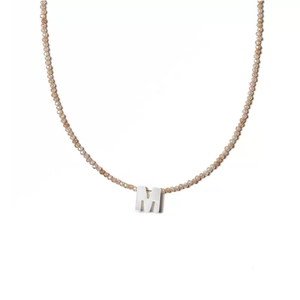 Elegant natural stone bead necklace with a white shell letter M pendant on white background