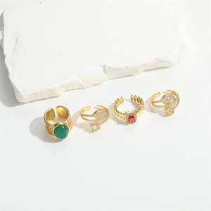 Set of four French vintage gold open rings with green, red gems and snake design