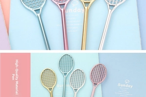 Detailed macro view of badminton racket shaped gel pens with metallic electroplated finish