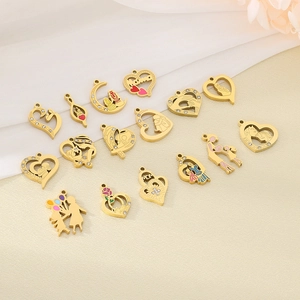 Macro shot of gold-plated heart-shaped mother and child charms with enamel details