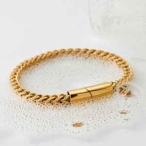 Classic gold double-row woven mesh stainless steel bracelet on white foam background