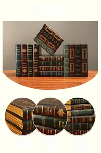 Close-up of vintage decorative book boxes with gold-foil spines and leather texture
