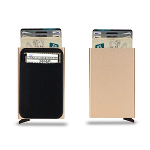 Macro detail of champagne gold metal RFID wallet showing automatic card pop-up mechanism
