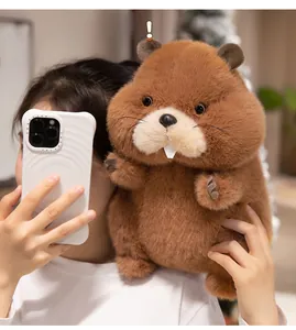 Close-up of soft brown plush marmot doll with fluffy texture and cute white teeth