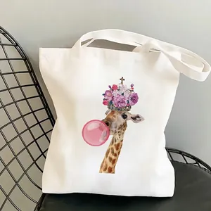 Cute giraffe canvas tote bag with floral crown and pink bubble on a minimalist chair