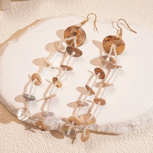 Bohemian dangle earrings with white seed beads and shell-textured circular charms
