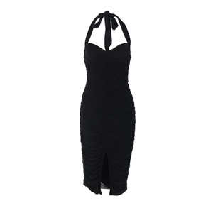 Detail of black halter dress featuring ruched fabric design and front slit detail