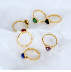 Detail view of 18K gold plated titanium steel rings with various cabochon gemstones