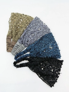 Detail of four-piece lace headbands with pearls and rhinestones in assorted dark colors