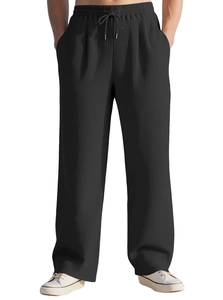 Close-up of men's black wide-leg trousers with pleated texture and drawstring waist