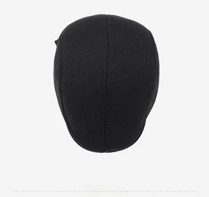 Top view of men's black wool flat cap showing premium knit texture and round minimalist shape