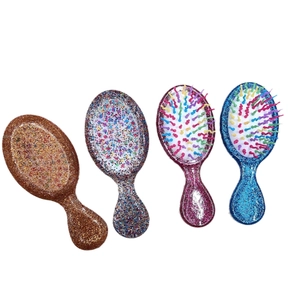 Set of four portable mini glitter hairbrushes with rainbow bristles in various colors