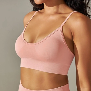 Detail of pink seamless knit sports bra showing breathable mesh texture and V-neckline