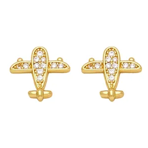 Macro detail of gold airplane stud earrings with pavé set sparkling zircon stones