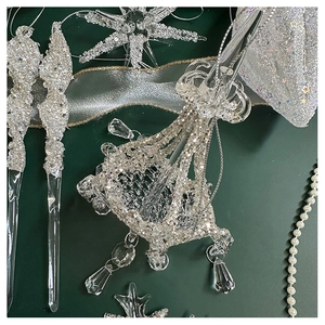 Close-up of sparkling silver snowflake and crystal icicle Christmas tree ornaments