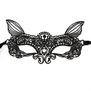Close-up of black lace cat ear mask with detailed embroidery and side ribbons