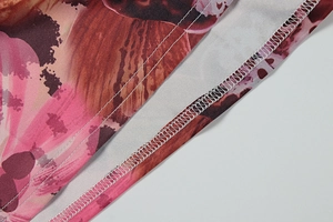 Detail of the high-quality overlock stitching and multi-color printed fabric texture
