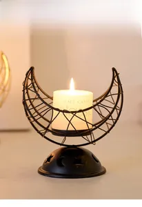 Detail of a crescent moon incense holder with a smokeless candle and镂空 star motifs