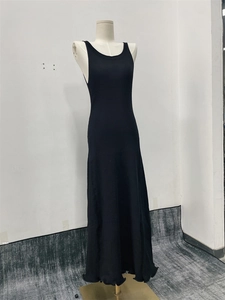 Detailed view of black knitted maxi dress featuring vertical ribbed texture and slim fit
